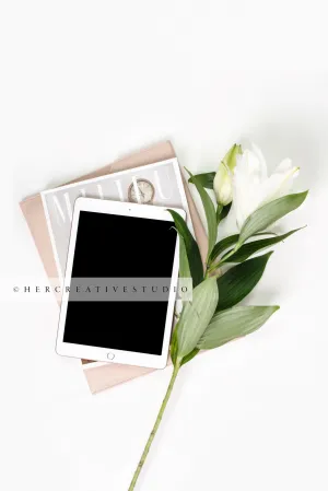 Tablet, Lily & Magazines on White Background