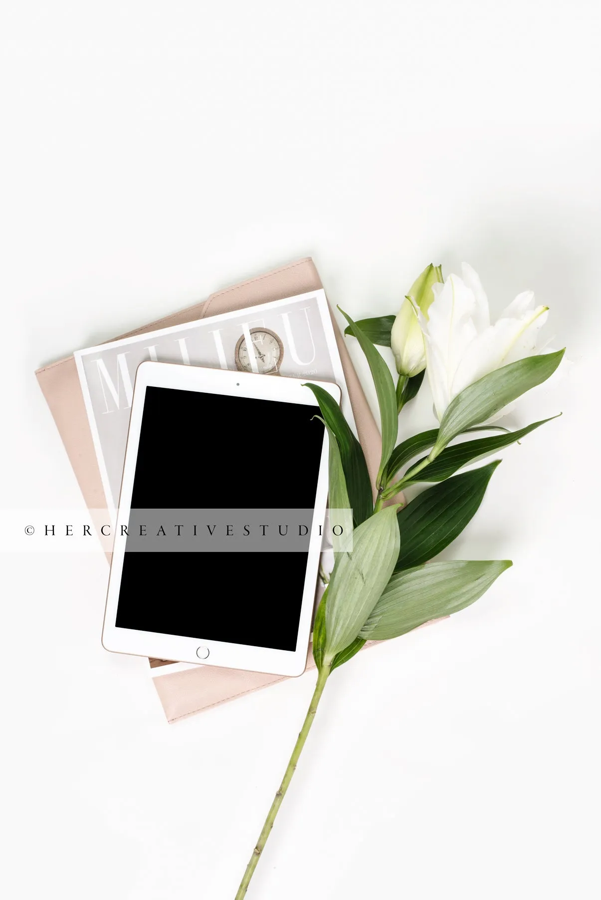 Tablet, Lily & Magazines on White Background